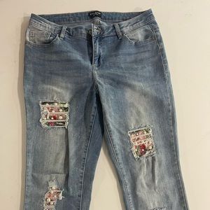 Bebe used normal wear womens size 31 ripped style with patch work and pearls